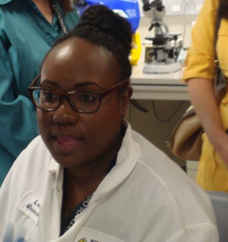 Lania Quaccoo, a clinical laboratory scientist in Hematology, spent time with tour participants to explain her work with white cell differentials.